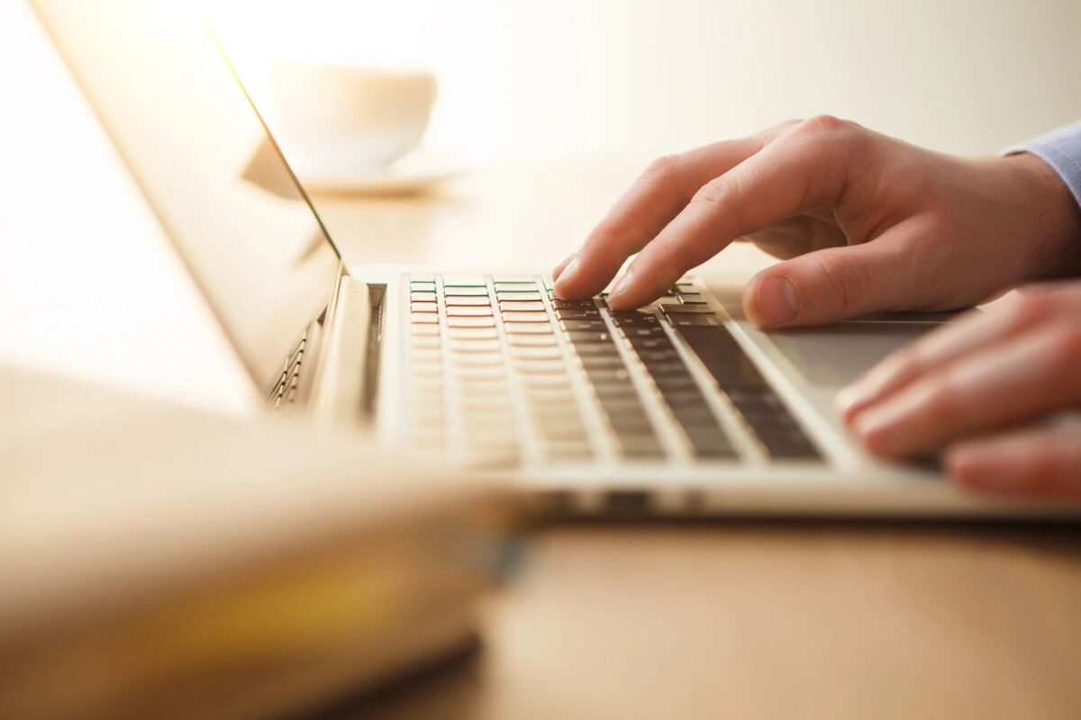 A person filling out tax forms on a computer, specifically 1040 schedule 3